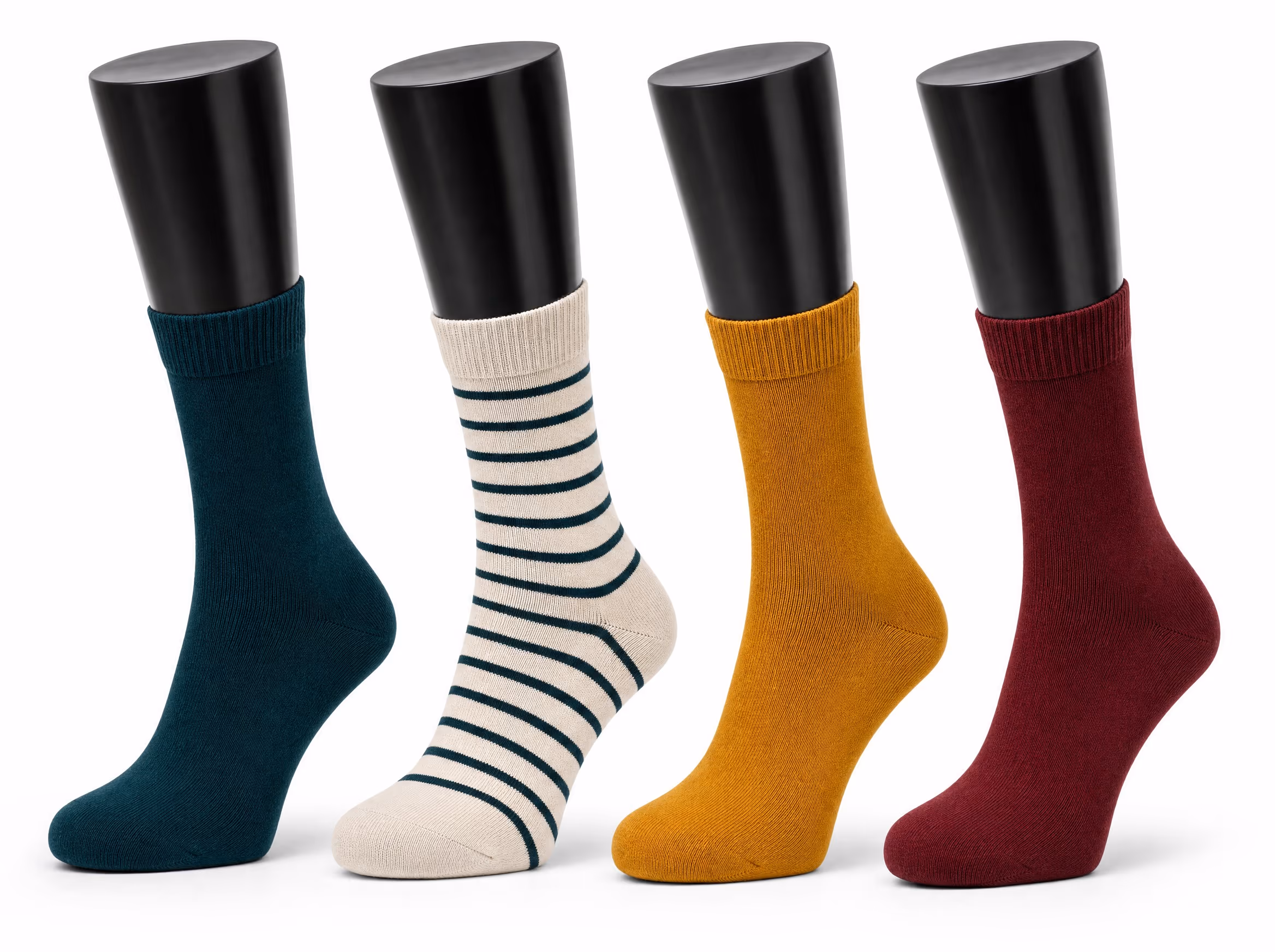 Four glossy black sock display forms, each wearing a mid-calf crew sock in a different colorway: deep teal, cream with teal stripes, mustard, and burgundy, on a white background