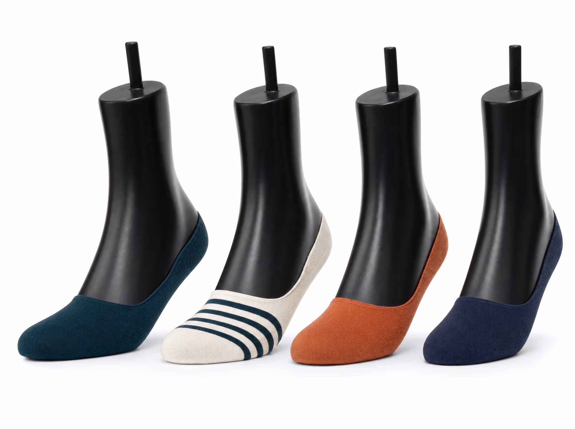 Four glossy black sock display forms, each wearing an invisible no-show sock in a different colorway: deep teal, cream with teal stripes, terracotta, and navy, on a white background