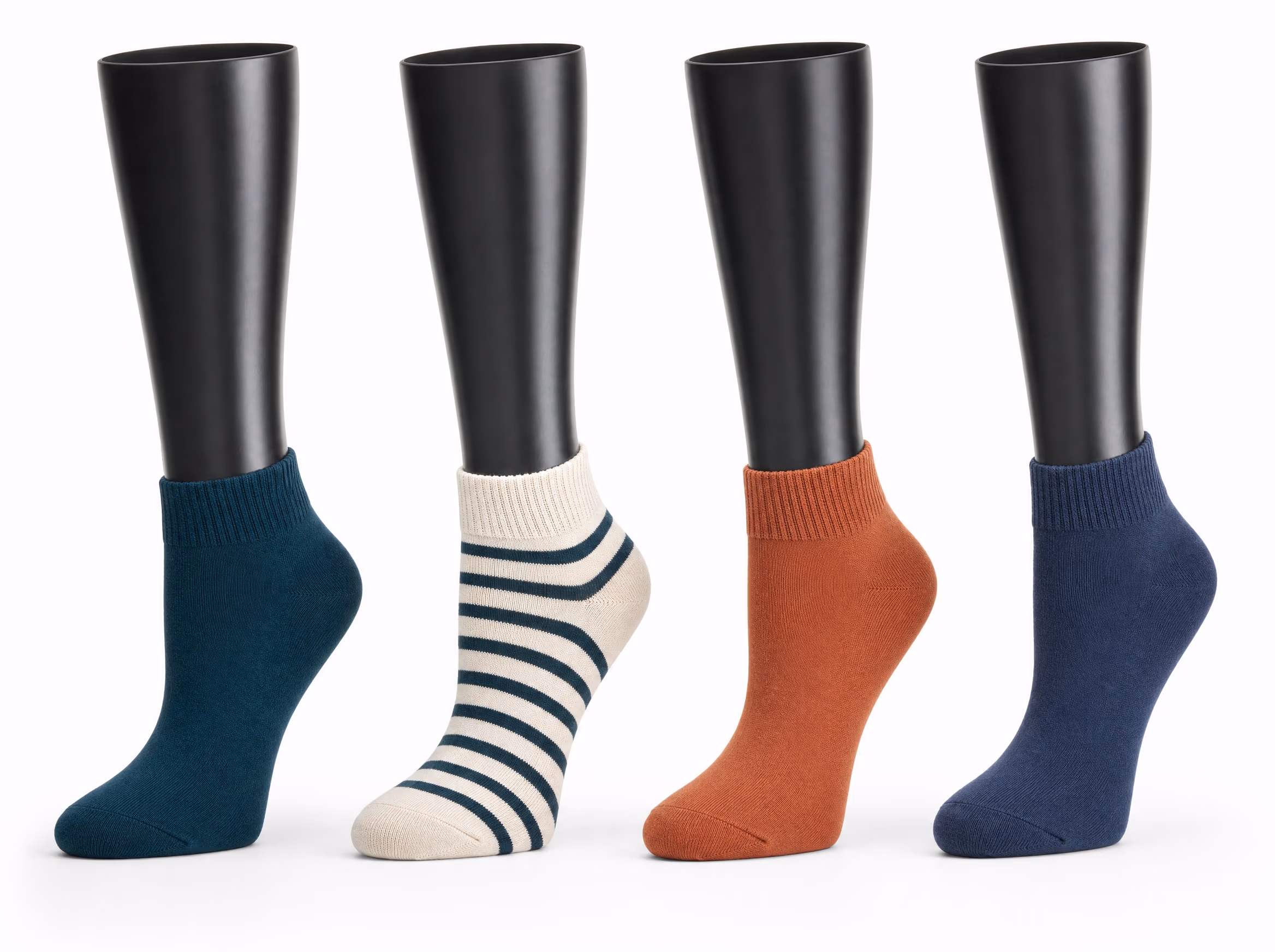 Four glossy black sock display forms, each wearing a quarter-height sock in a different colorway: deep teal, cream with teal stripes, terracotta, and navy, on a white background